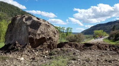 One of two boulders landed directly on the highway, the other (shown above) plowed through creating a 10- to 15- foot trench.
