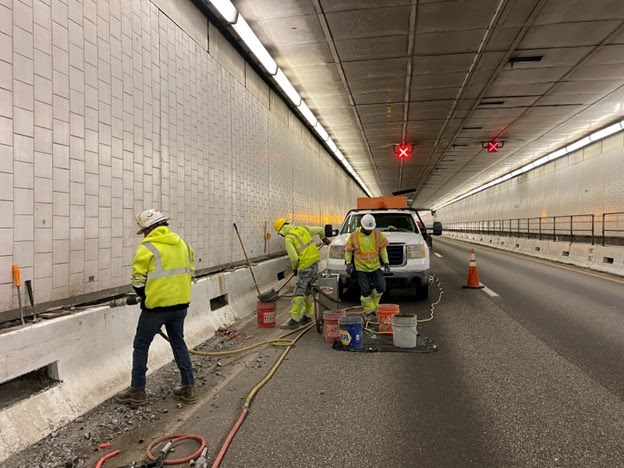 Construction crews working on repairs on I-70 in the Eisenhower Tunnel