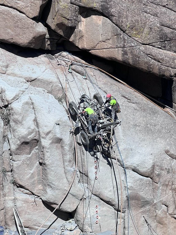 Crews working on the side of a rockface
